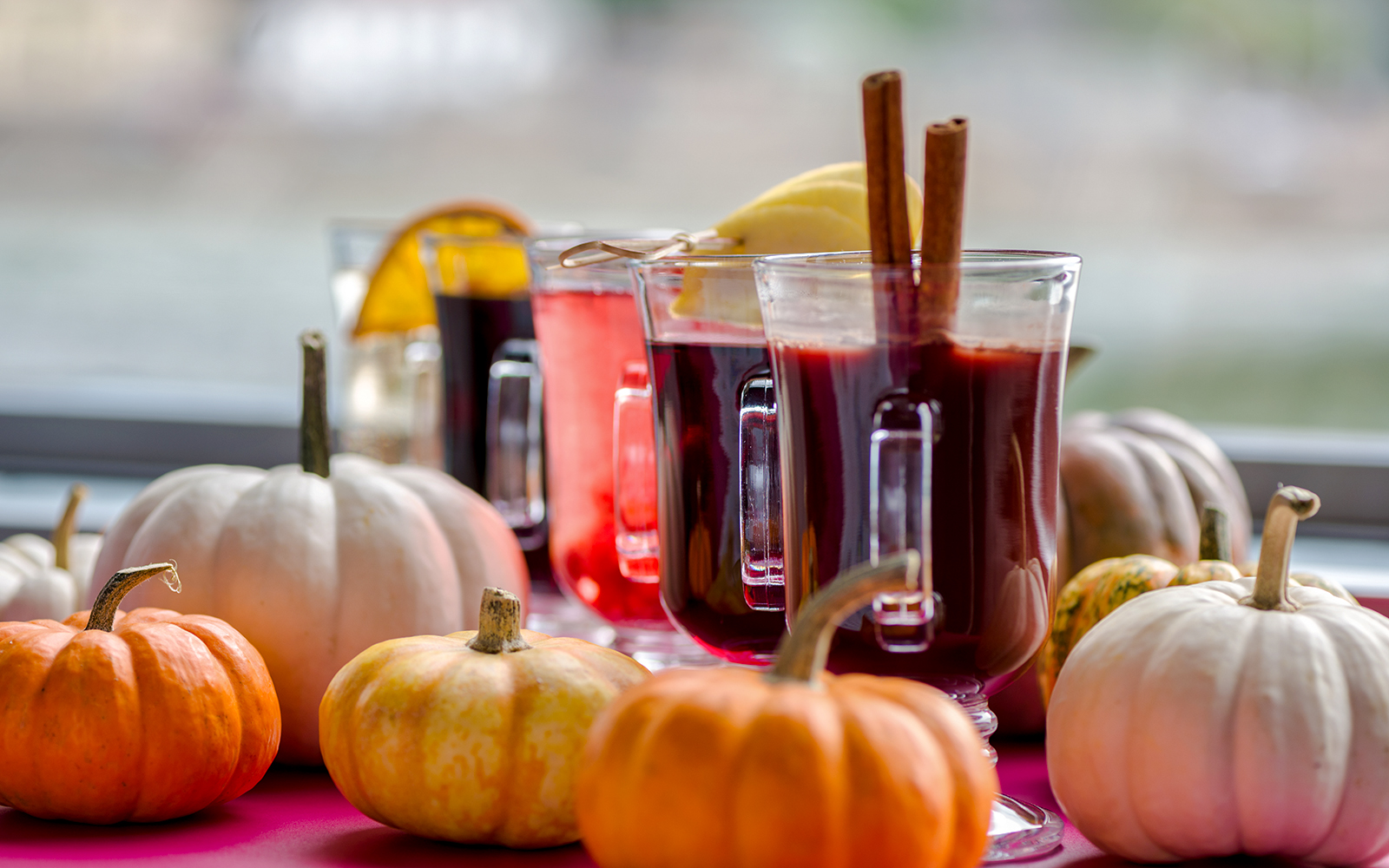 Mulled wine glasses with cinnamon sticks on Danube River nighttime cruise.