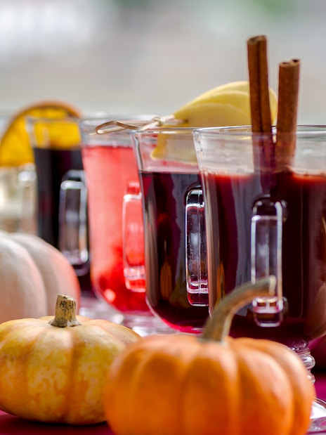 Mulled wine glasses with cinnamon sticks on Danube River nighttime cruise.
