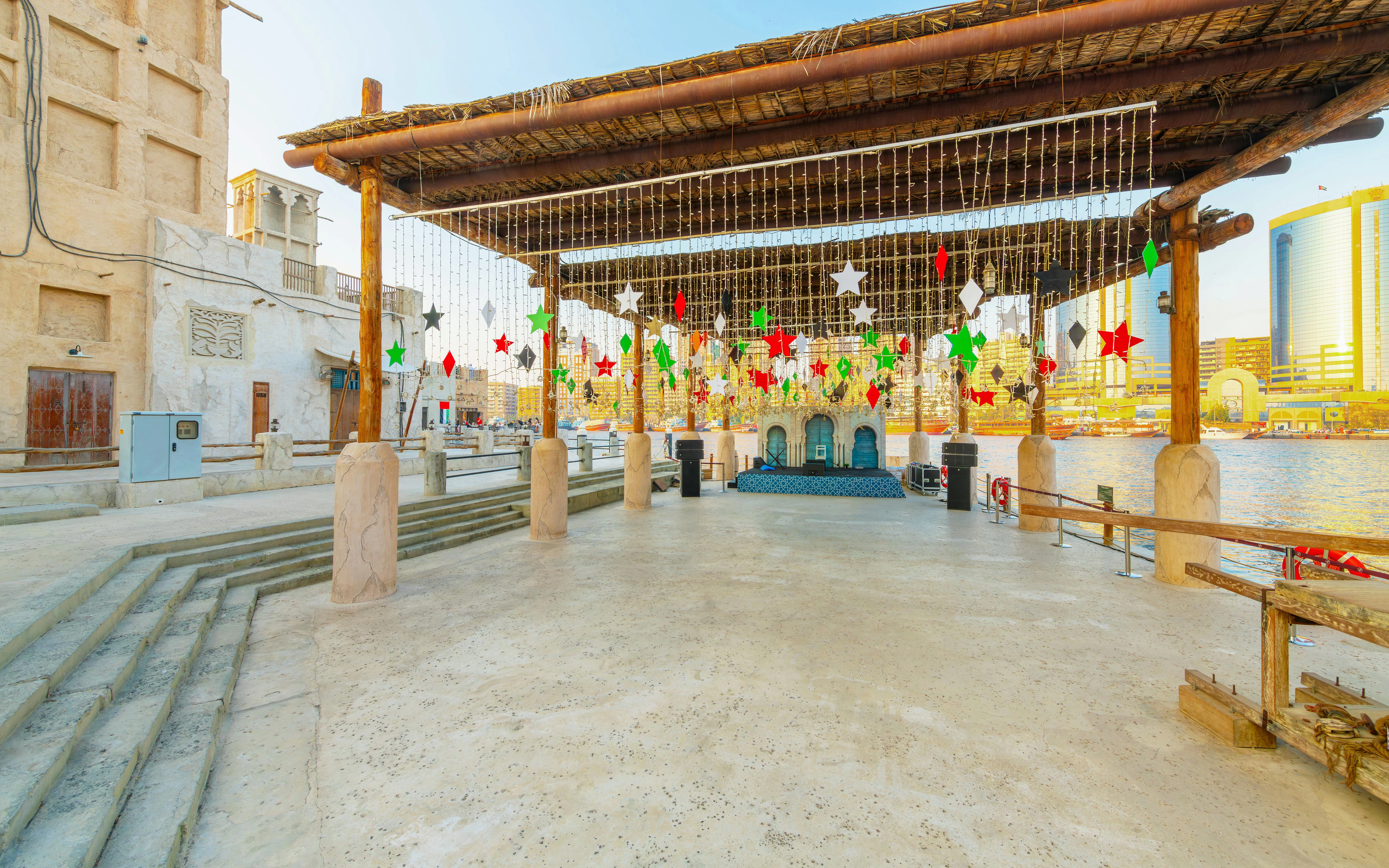 Covered outdoor area with colorful star decorations at Al Seef, Dubai Creek.