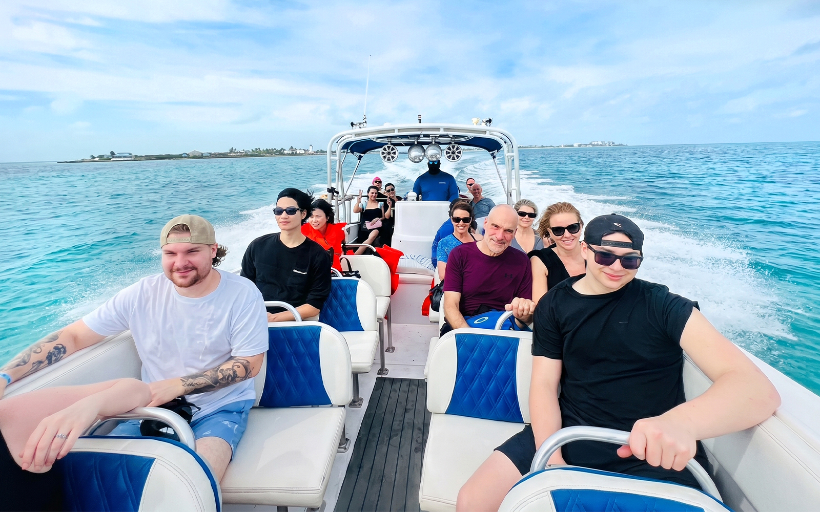 Group on a boat heading to Rose Island for a day trip with snorkeling and swimming with pigs.