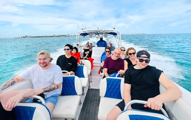 Group on a boat heading to Rose Island for a day trip with snorkeling and swimming with pigs.