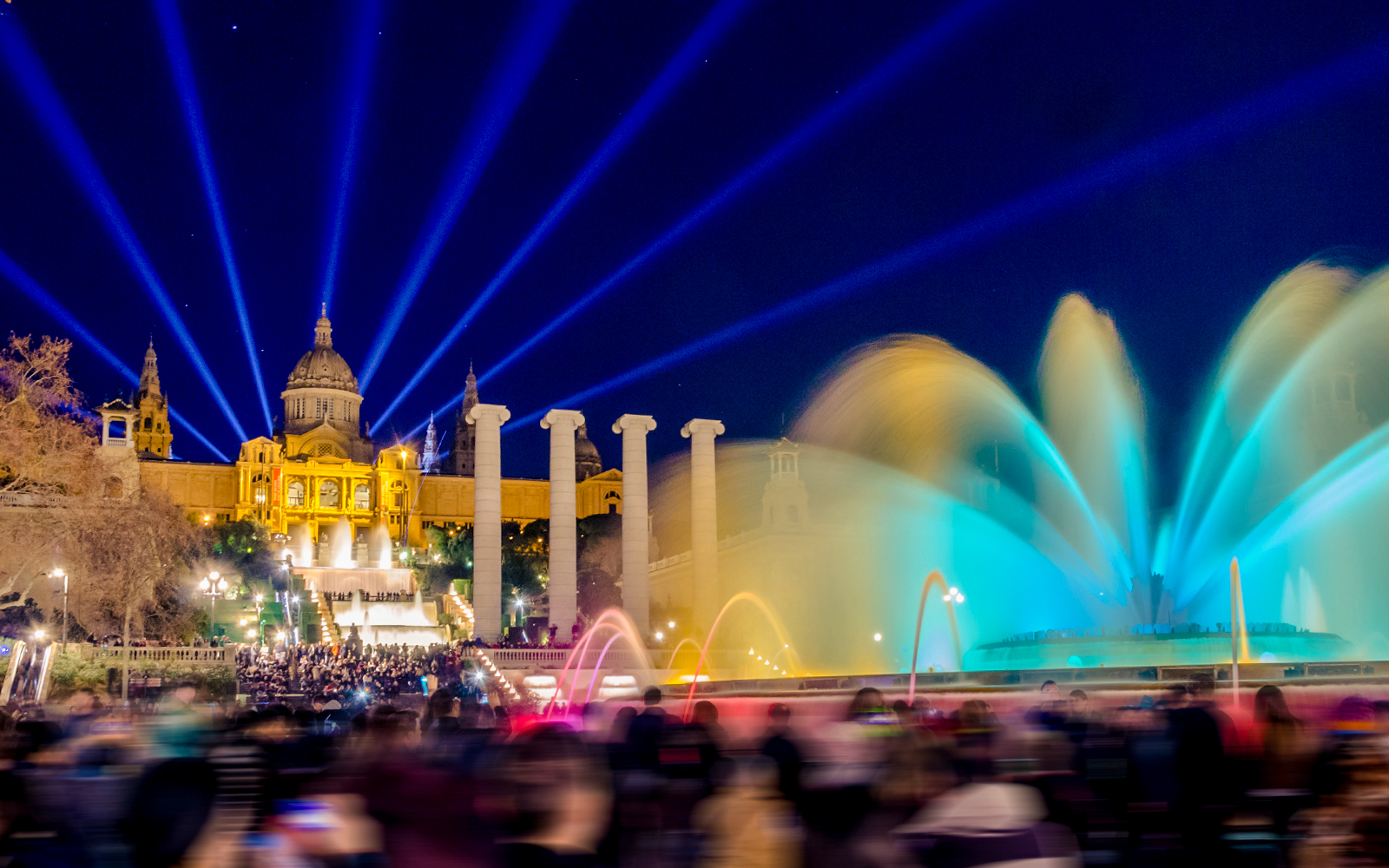 Magic Montjuic Fountain Barcelona illuminated at night with colorful water display.