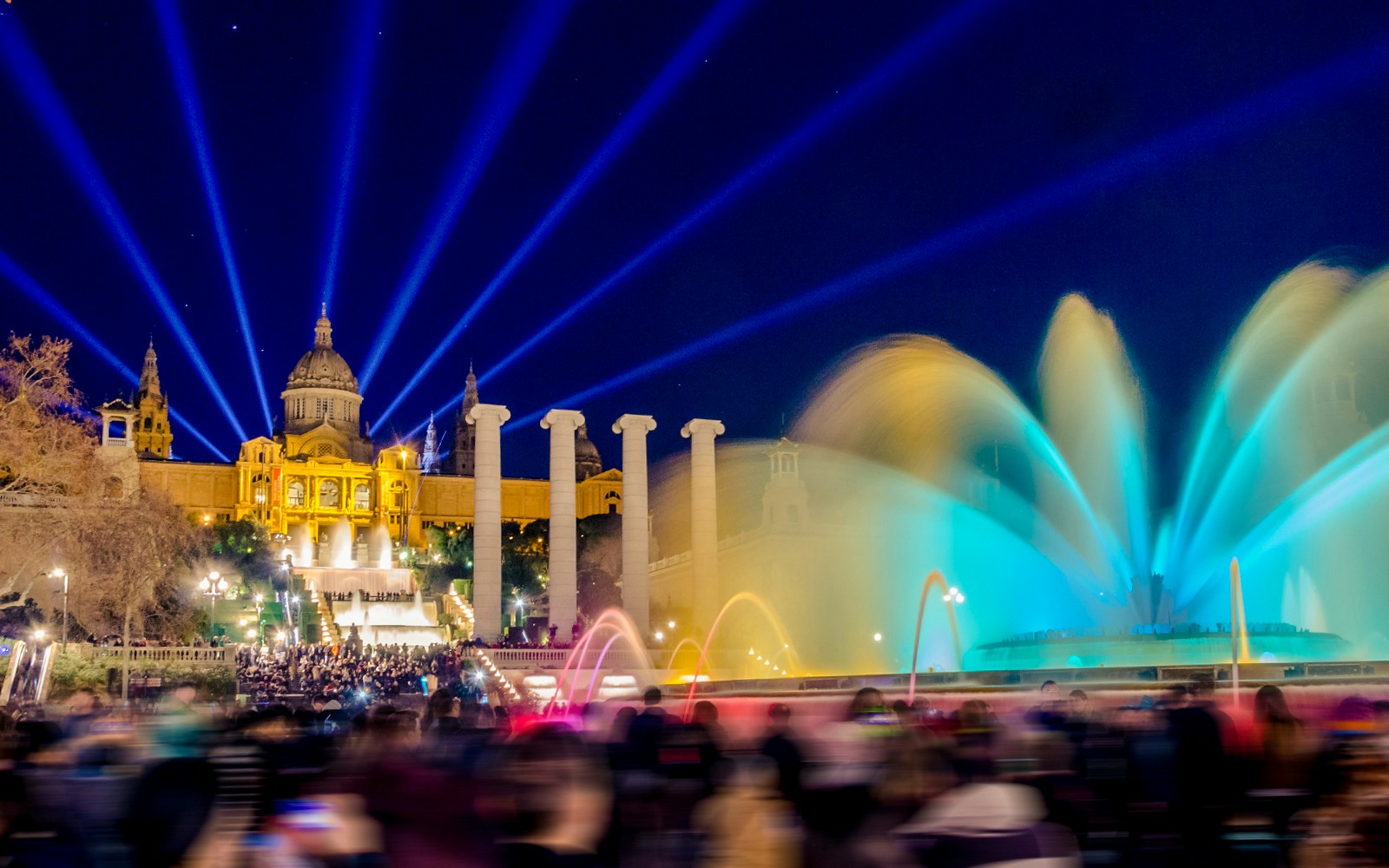 Magic Montjuic Fountain Barcelona illuminated at night with colorful water display.