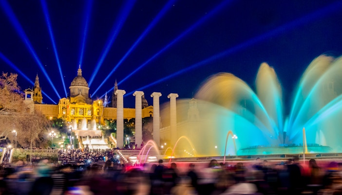 Magic Montjuic Fountain Barcelona illuminated at night with colorful water display.