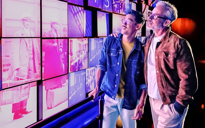 Tourists viewing historical images at One World Observatory, New York City.