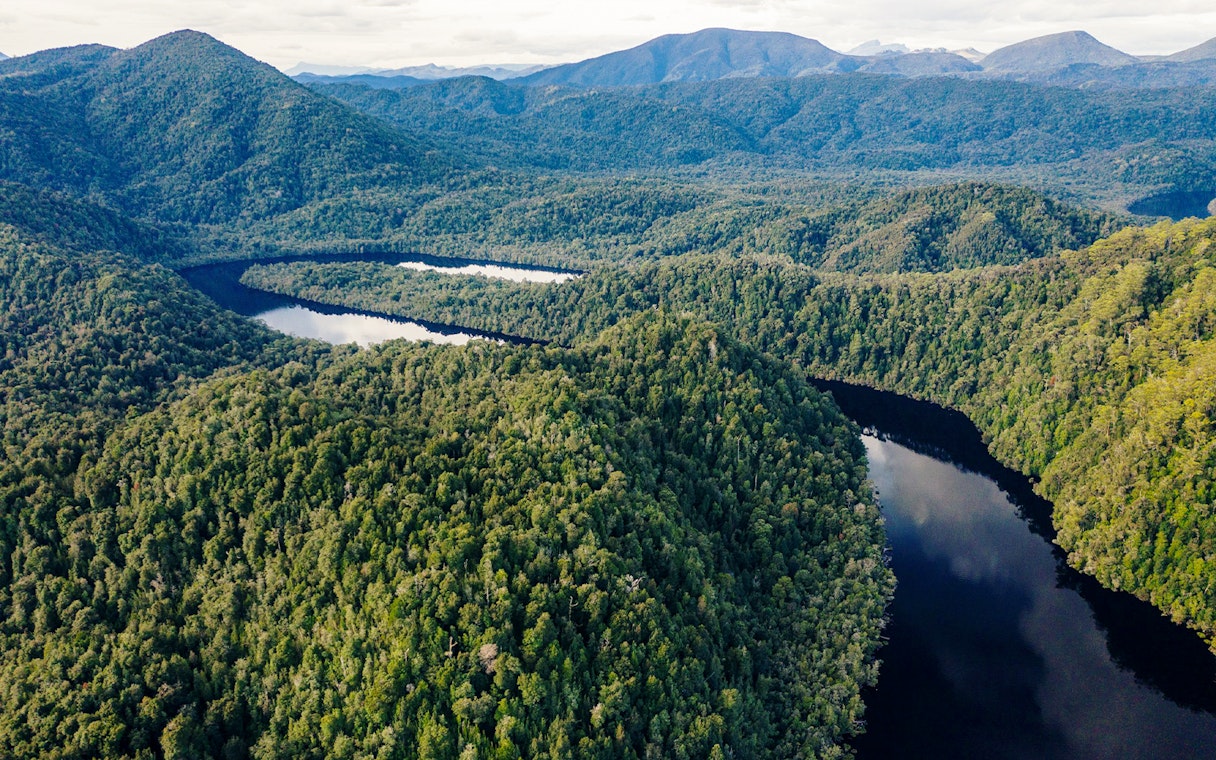 Gordon River winding through lush forested landscape in Tasmania, Australia.