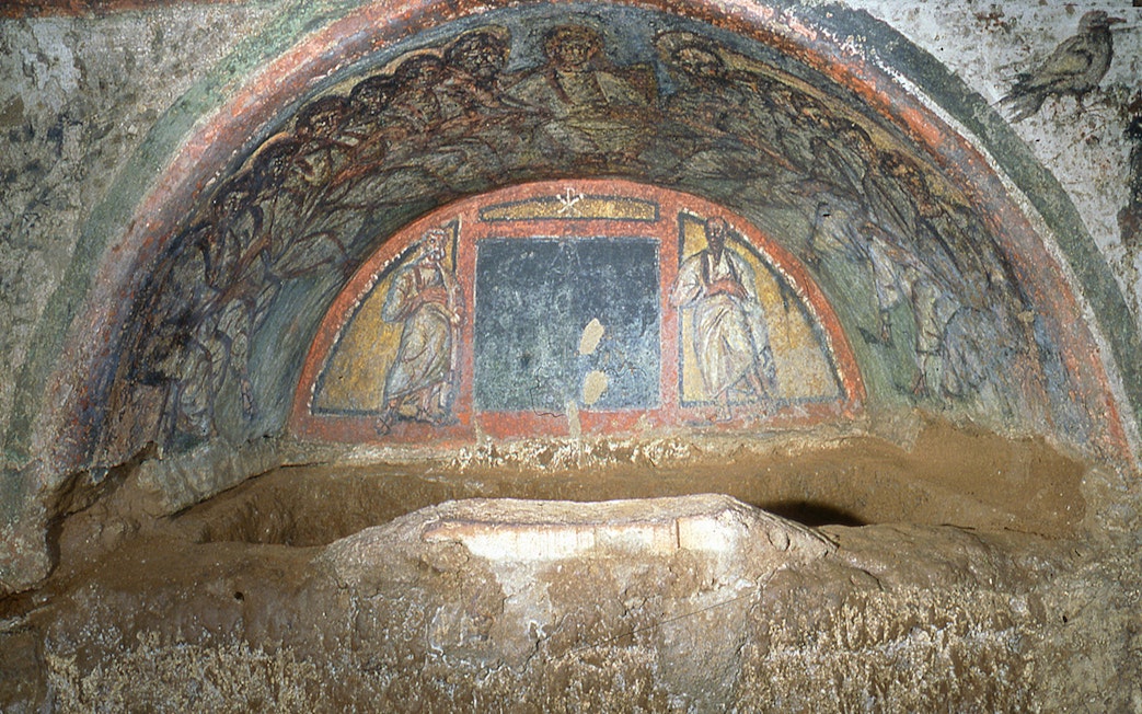 Wall paintings depicting biblical figures in the Catacombs of Domitilla, Rome.
