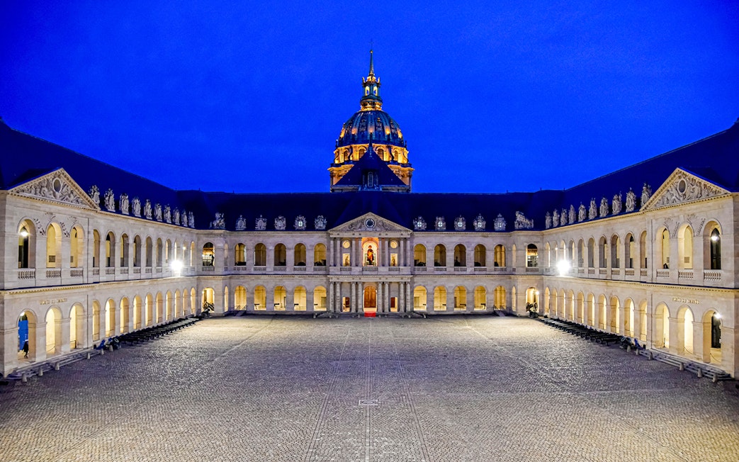 Courtyard of the Army Museum at Les Invalides, Paris, illuminated at night.