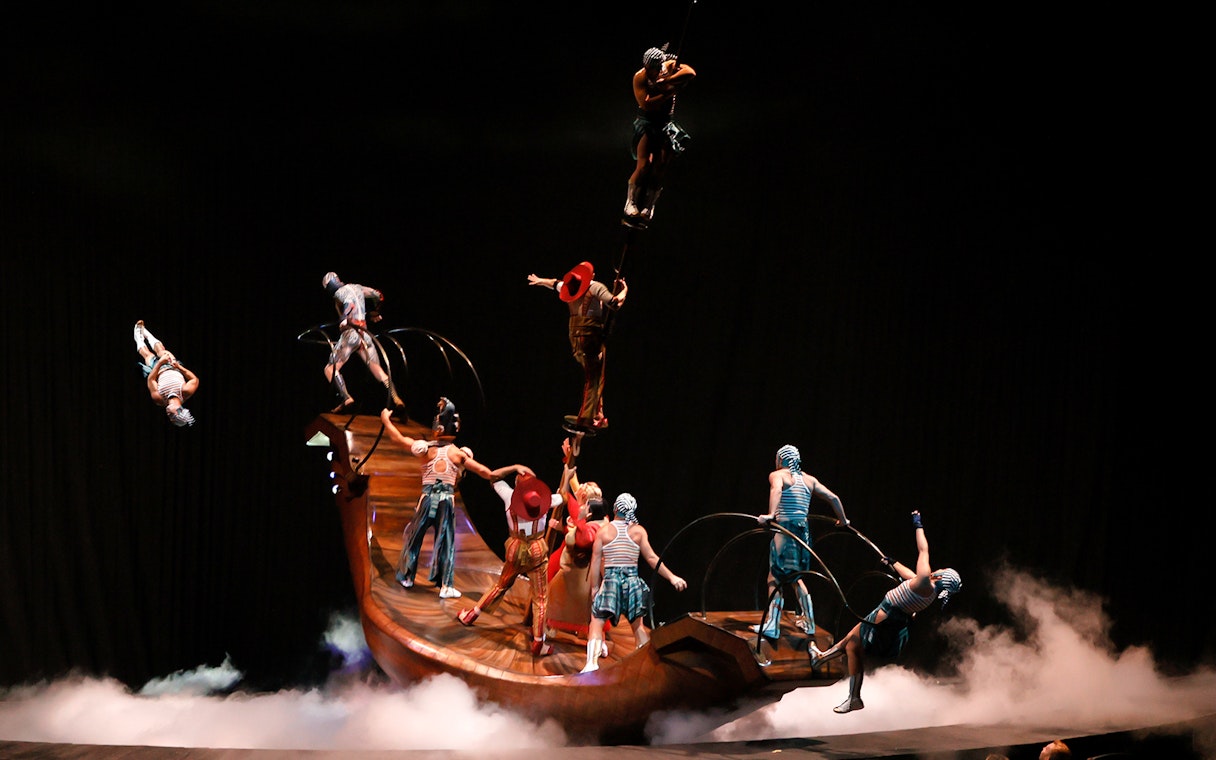 Acrobats performing on a rotating platform in Cirque du Soleil KÀ show.