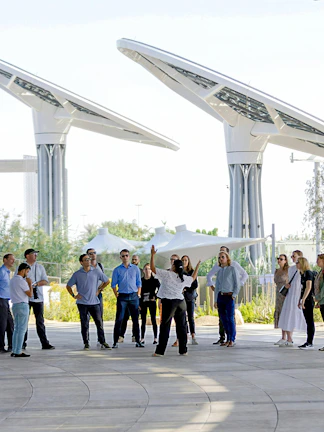 Guide engaging with tourists at Expo City Dubai pavilion.