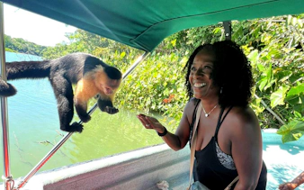White-faced capuchin monkey on boat canopy frame during Panama wildlife tour.