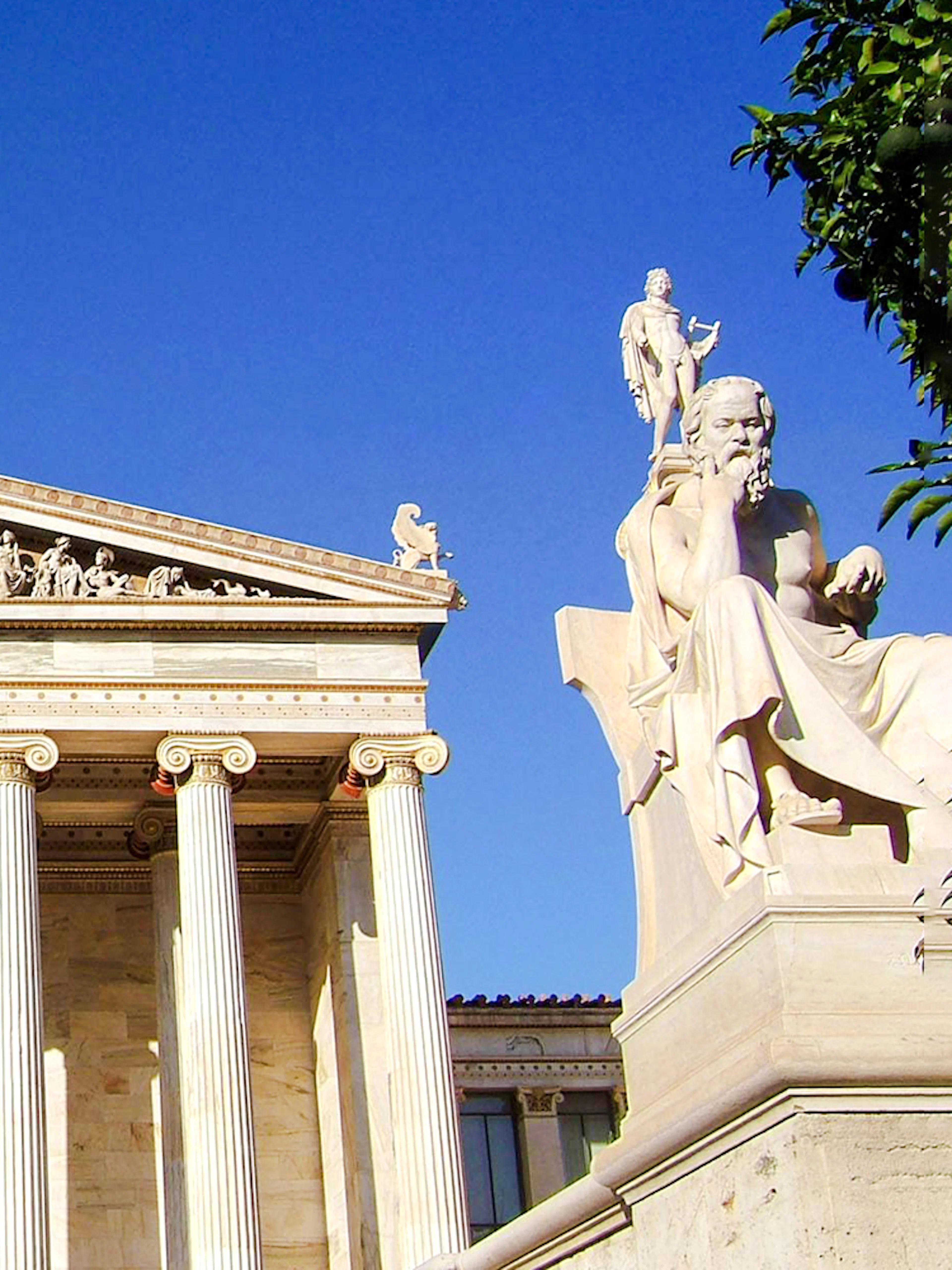 Academy of Athens facade with statues of philosophers in Greece.