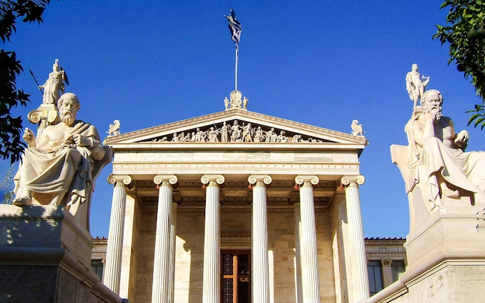 Academy of Athens facade with statues of philosophers in Greece.