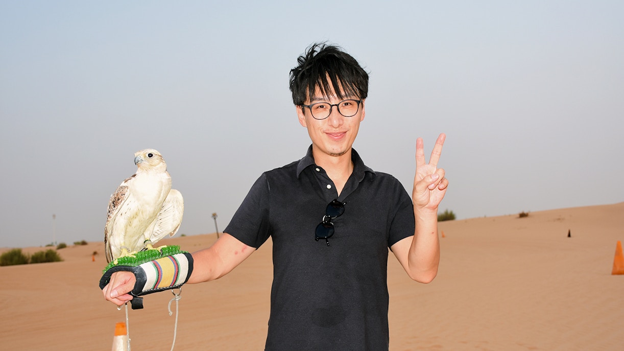 A man with a flacon on his hand.