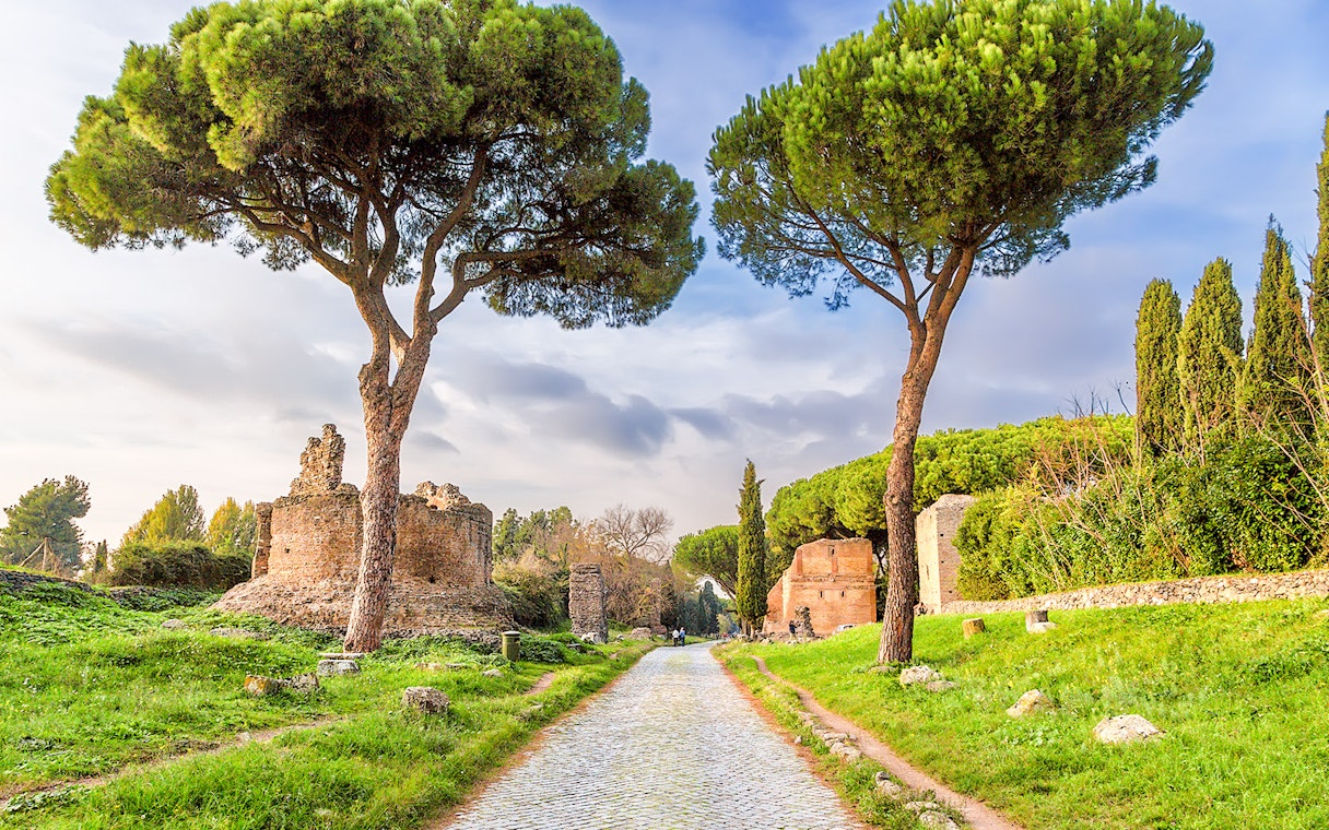 Ancient ruins and trees along the Appian Way in Rome.