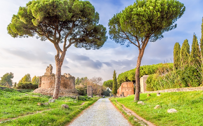 Ancient ruins and trees along the Appian Way in Rome.
