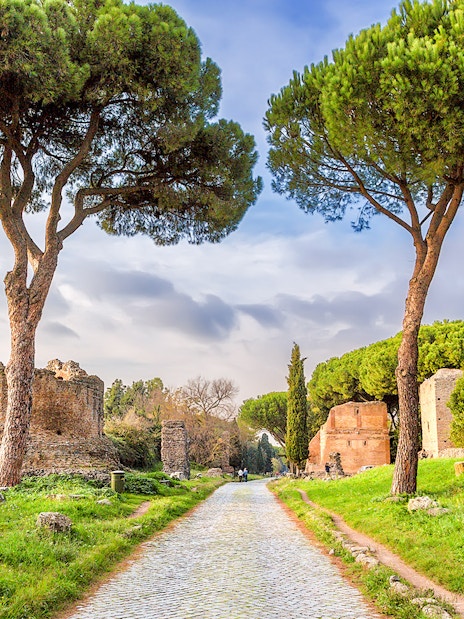Ancient ruins and trees along the Appian Way in Rome.