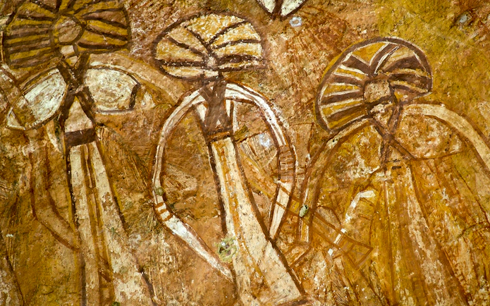 Aboriginal rock art in Kakadu National Park, Australia, depicting ancient figures.