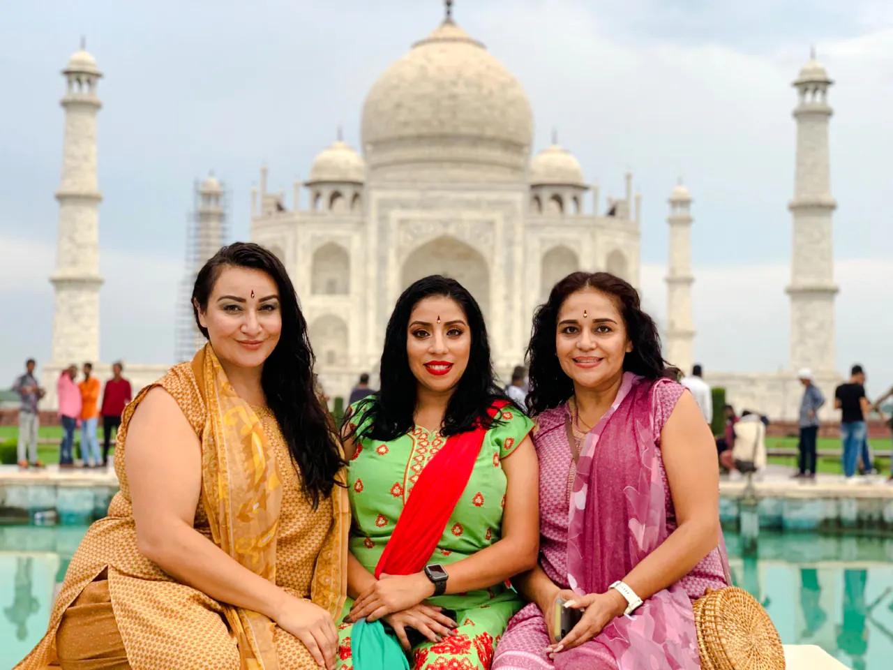 Visitors at the Taj Mahal, Agra, with the iconic marble mausoleum in the background.