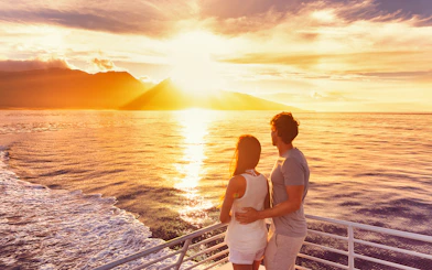 Couple enjoying sunset on Split Riviera cruise with drinks.