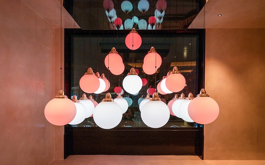 Hanging spherical lights in Flottille's snack & go setting.