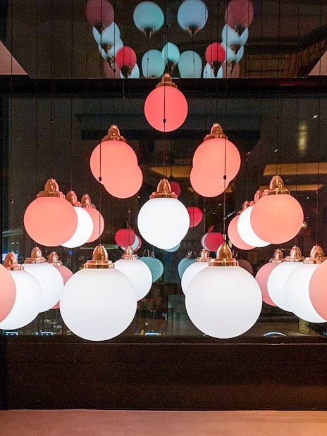 Hanging spherical lights in Flottille's snack & go setting.