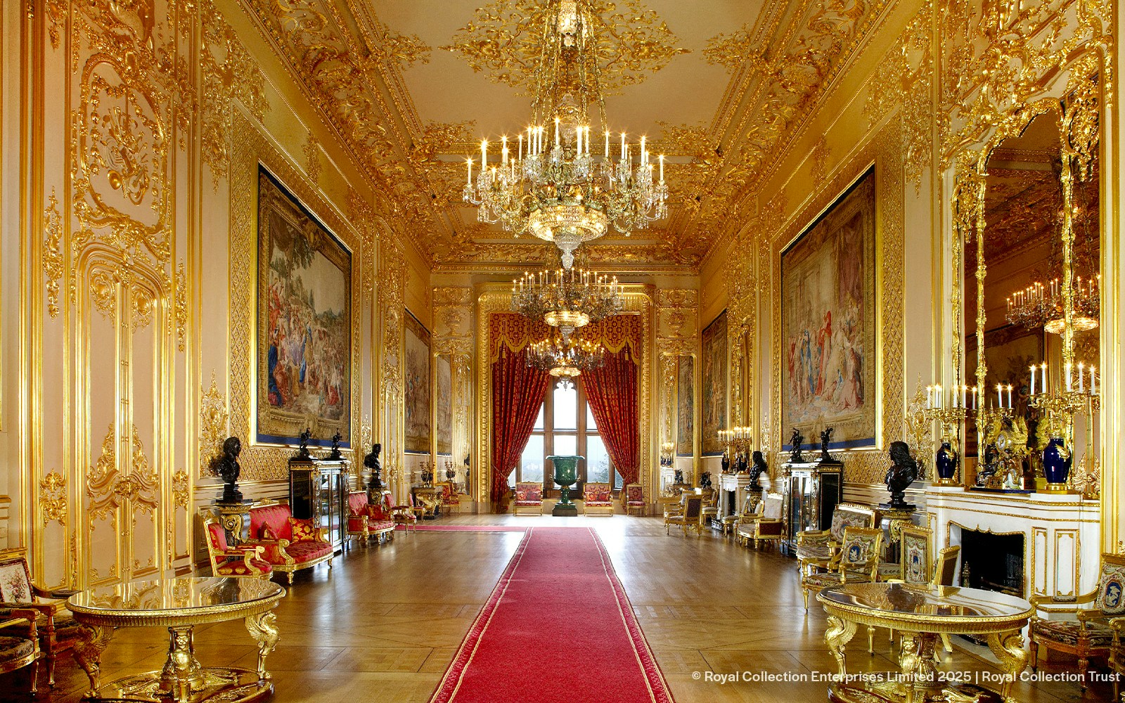 Windsor Castle interior with ornate chandeliers, gilded walls, and red carpet.