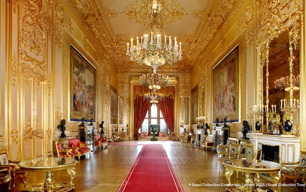 Windsor Castle interior with ornate chandeliers, gilded walls, and red carpet.