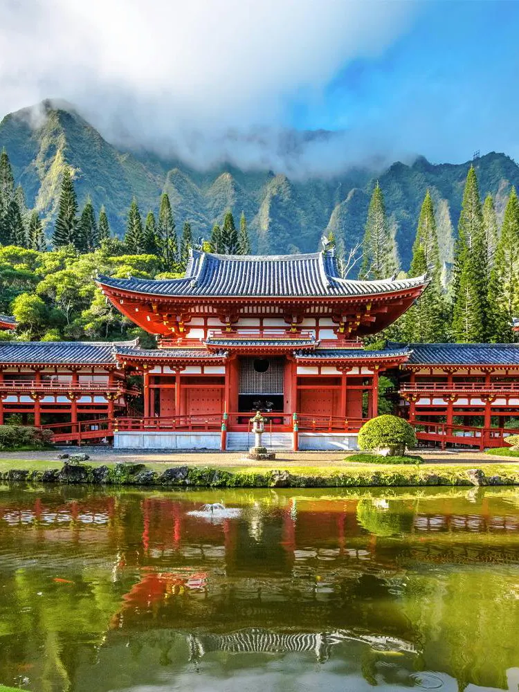 Byodo-In Temple with mountains and greenery in the Valley of the Temples, Oahu, Hawaii.