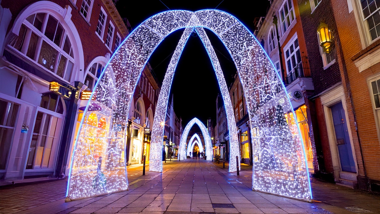 London Christmas Lights illuminating streets during night bus tour.