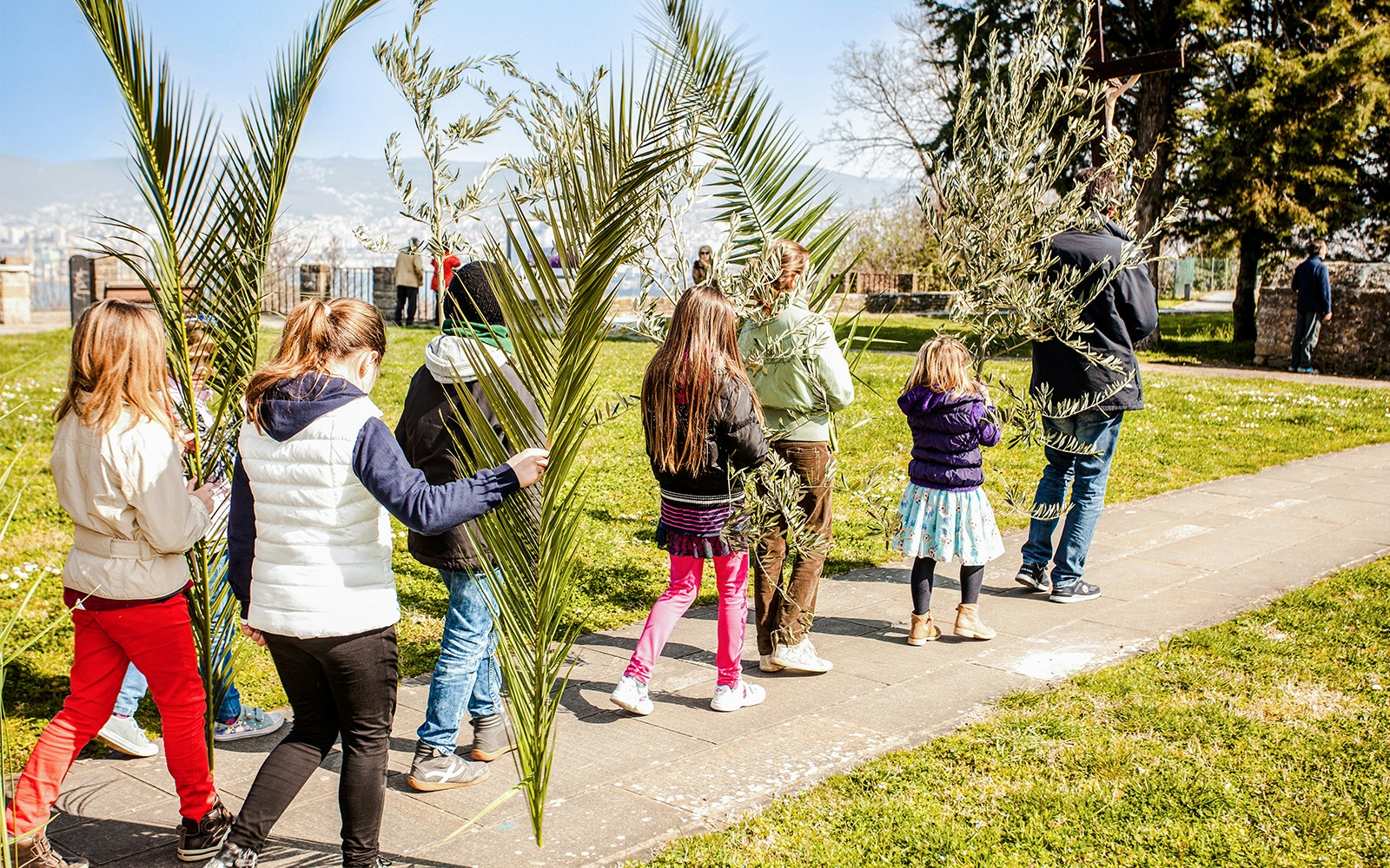 Palm Sunday procession with people holding palm branches in Milan