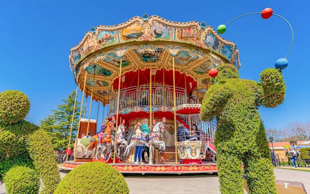 Carousel ride at Paultons Park with topiary figures, part of Peppa Pig World Express Tour.
