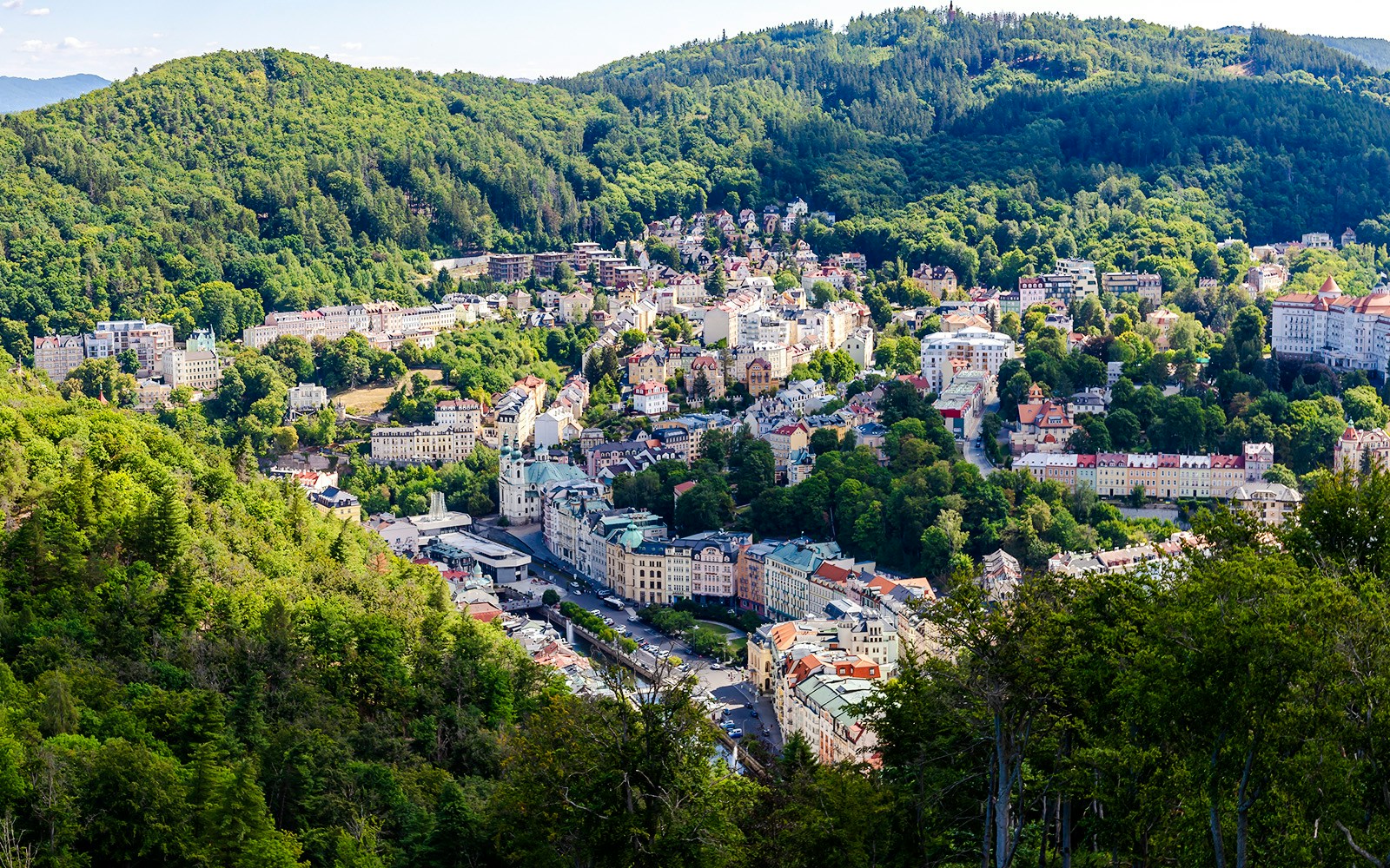 View of Karlovy Vary, Czech Republic, surrounded by lush forests from Diana Observation Tower.