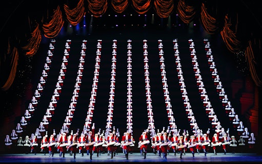 Radio City Rockettes performing in Christmas Spectacular with synchronized dance routine.
