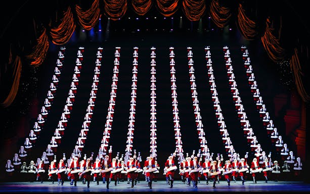Radio City Rockettes performing in Christmas Spectacular with synchronized dance routine.