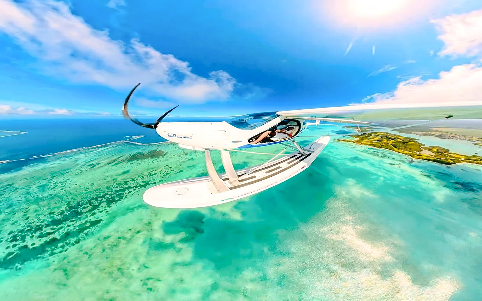 Seaplane flying over turquoise waters near Mauritius on the Scenic Seaplane Tour.