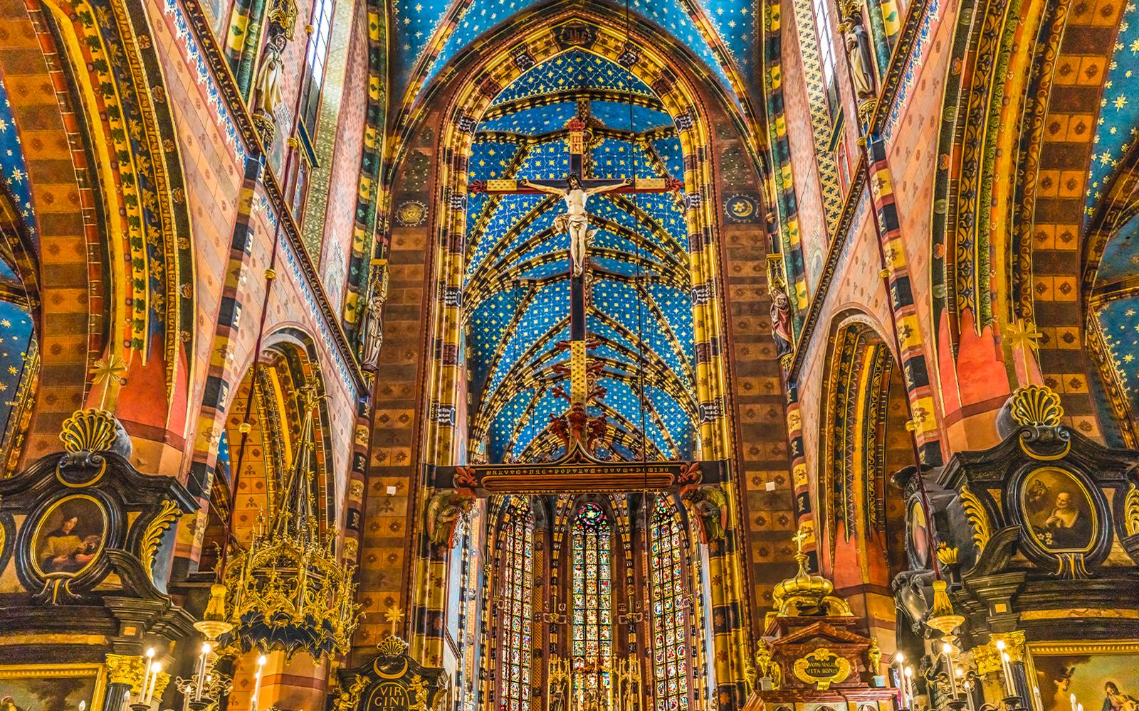 Crucifix and ornate ceiling inside St Mary's Basilica, Krakow, Poland.