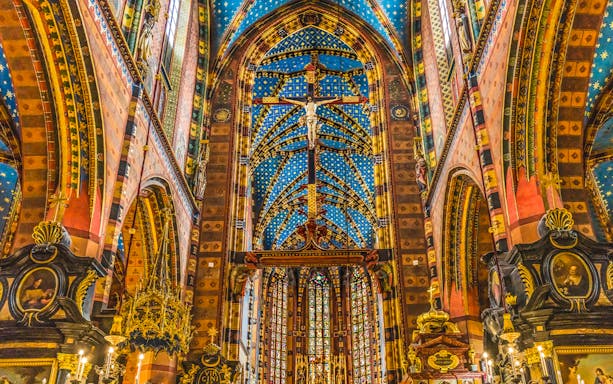 Crucifix and ornate ceiling inside St Mary's Basilica, Krakow, Poland.