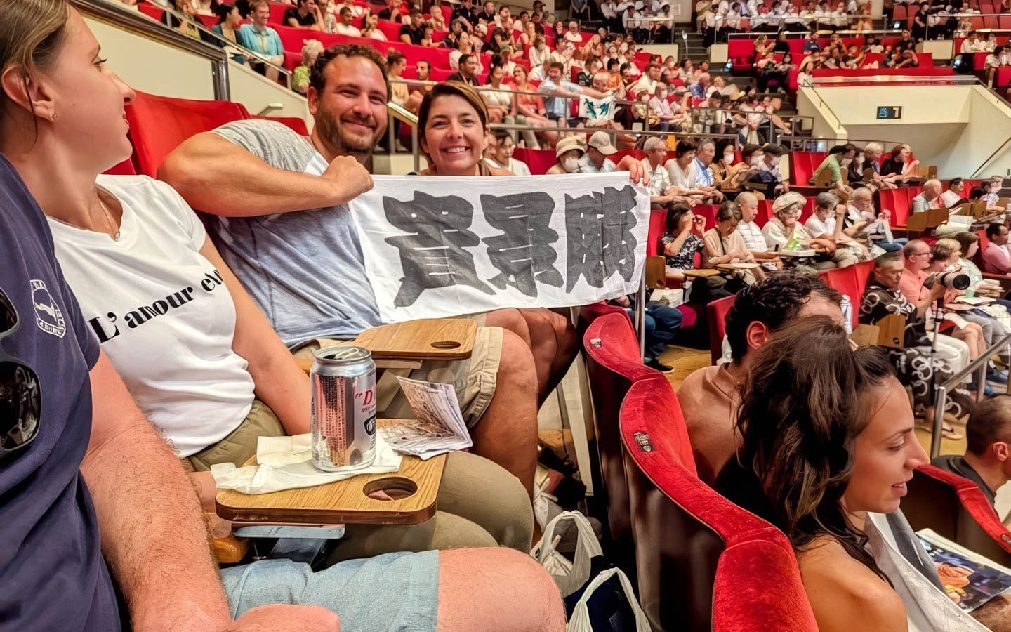 Spectators holding a banner at the Tokyo Grand Sumo Tournament.