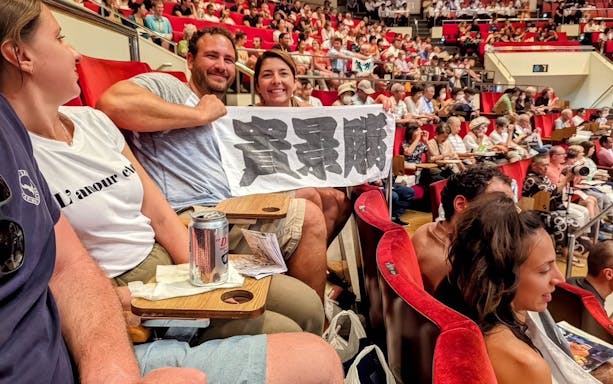 Spectators holding a banner at the Tokyo Grand Sumo Tournament.