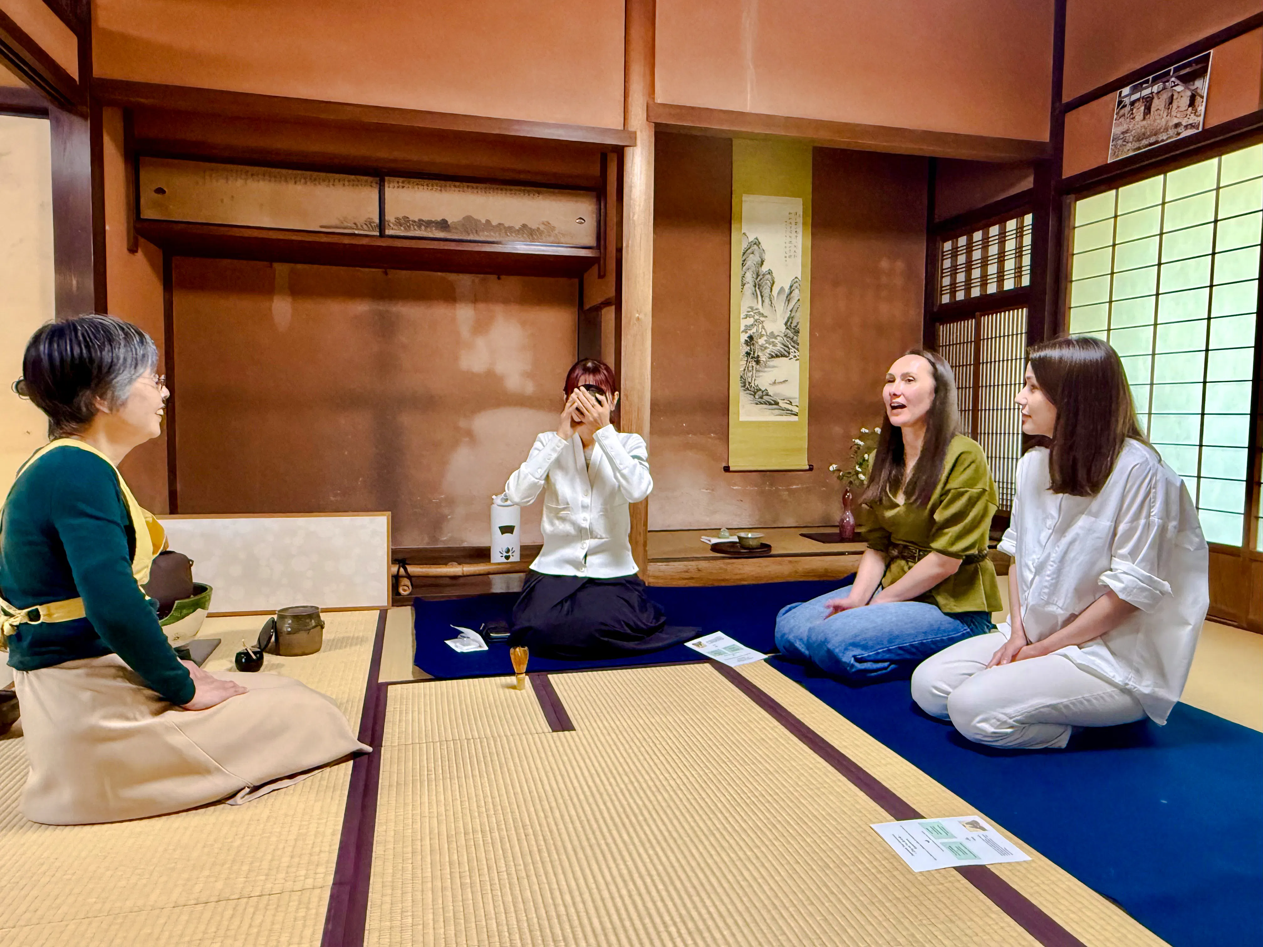 Local tea ceremony at cultural house in Hyogo with participants seated on tatami mats.