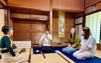 Local tea ceremony at cultural house in Hyogo with participants seated on tatami mats.