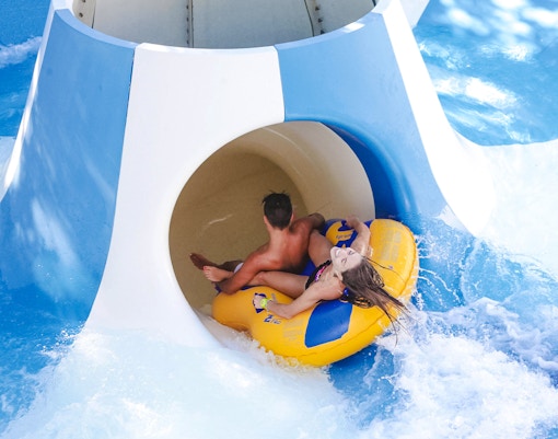 Visitors enjoying water slides at Aquafan Water Park, Riccione, Italy.