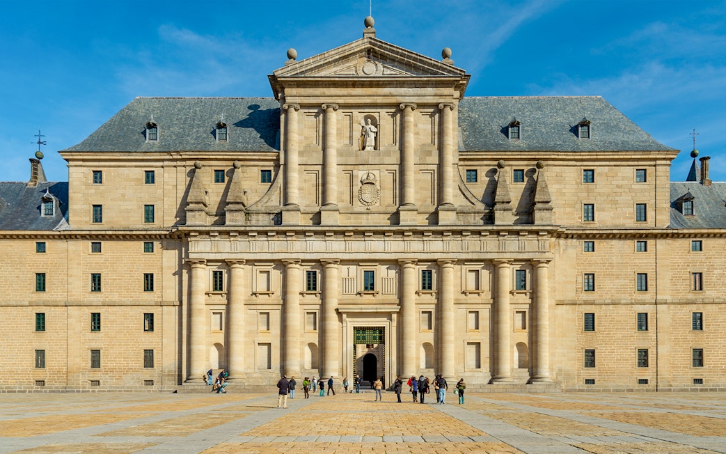 Monastery of San Lorenzo de El Escorial facade with visitors, Spain.