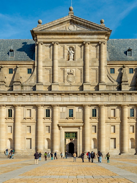 Monastery of San Lorenzo de El Escorial facade with visitors, Spain.