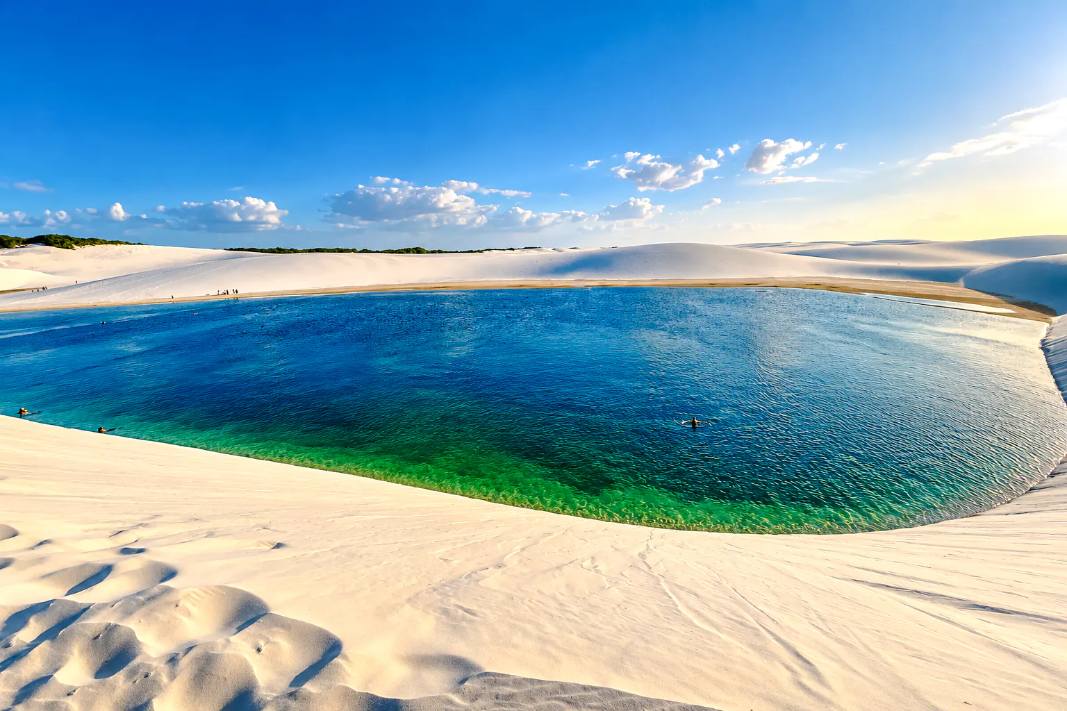 Lagoa Bonita lagoon surrounded by sand dunes in Barreirinhas, part of the 4x4 circuit tour.