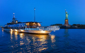 Bateaux Premier Dinner Cruise near Statue of Liberty at dusk.