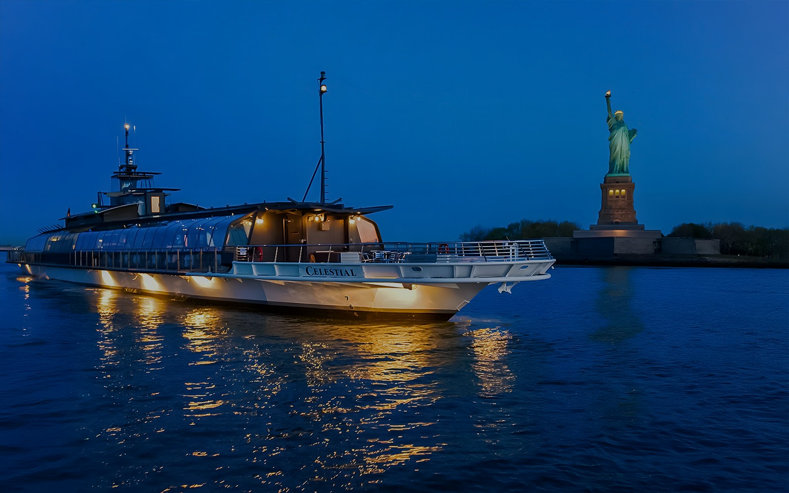 Bateaux Premier Dinner Cruise sailing near Statue of Liberty in New York City.
