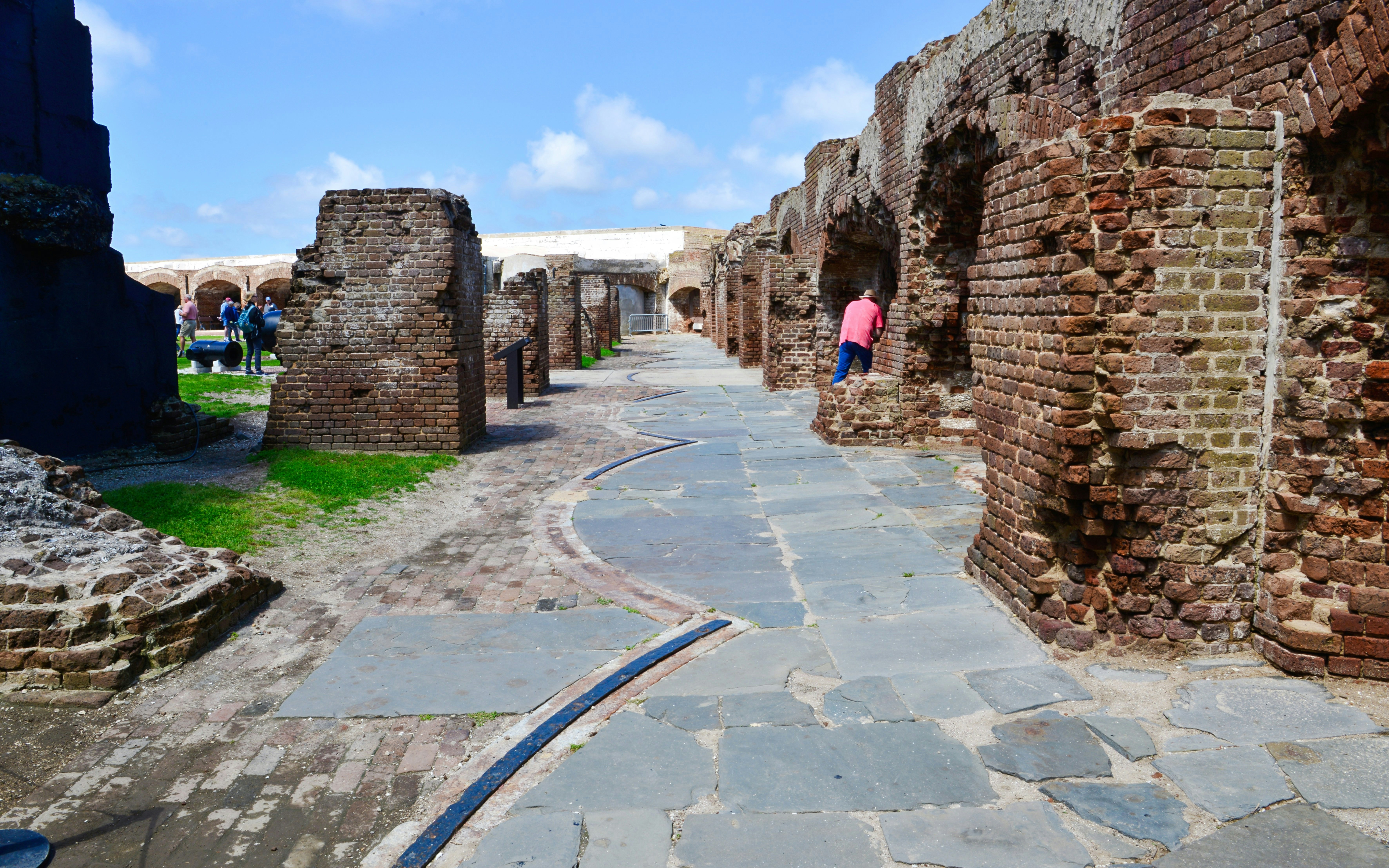 Inner walls and pathways of Fort Sumter, Charleston, with visitors exploring.