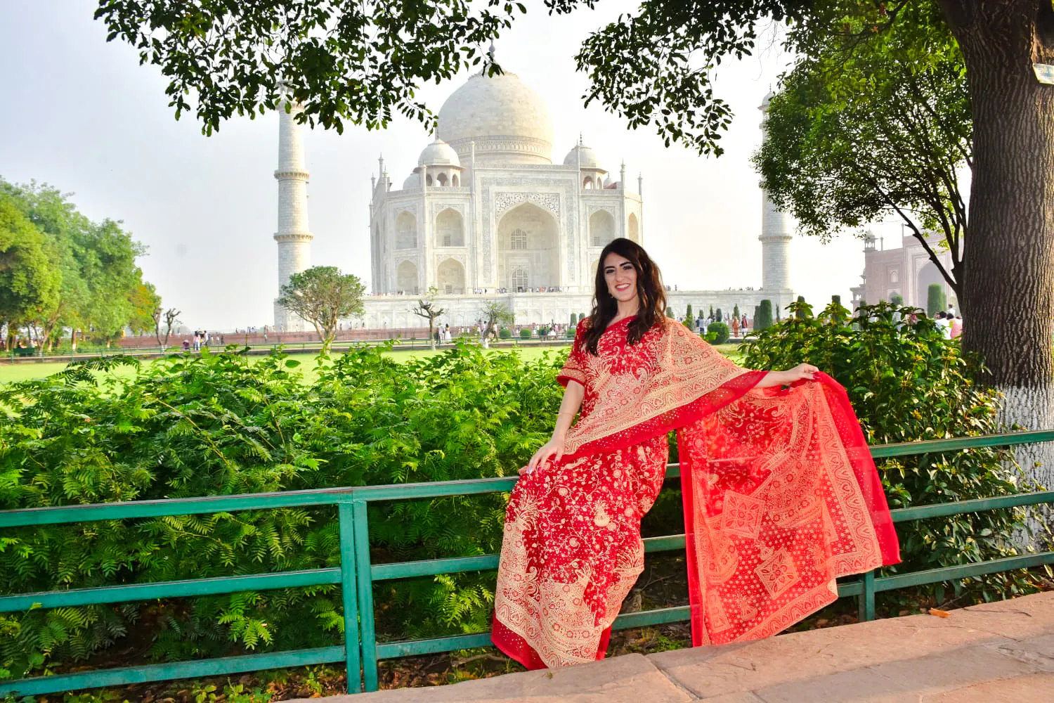 Visitor in traditional attire at the Taj Mahal during sunrise, Agra tour.